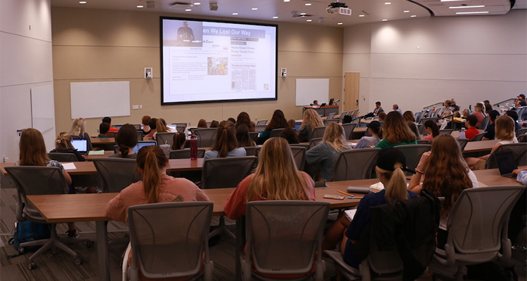 Carol Tomé speaking to students