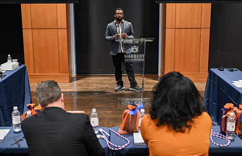 Woman setting up a bulletin at the SEC Pitch Competition