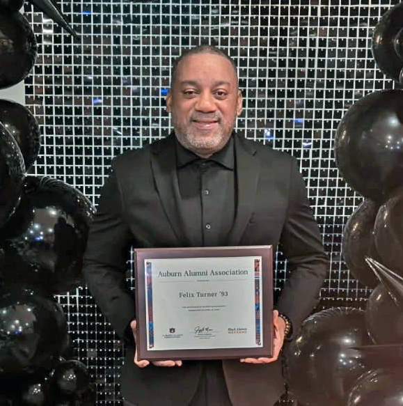 Felix Turner holding award 