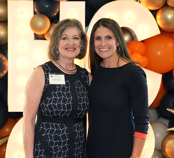 Two women alumnae standing together
