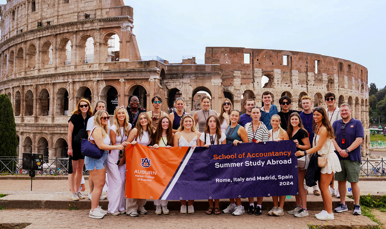 Group of people in front of roman coliseum