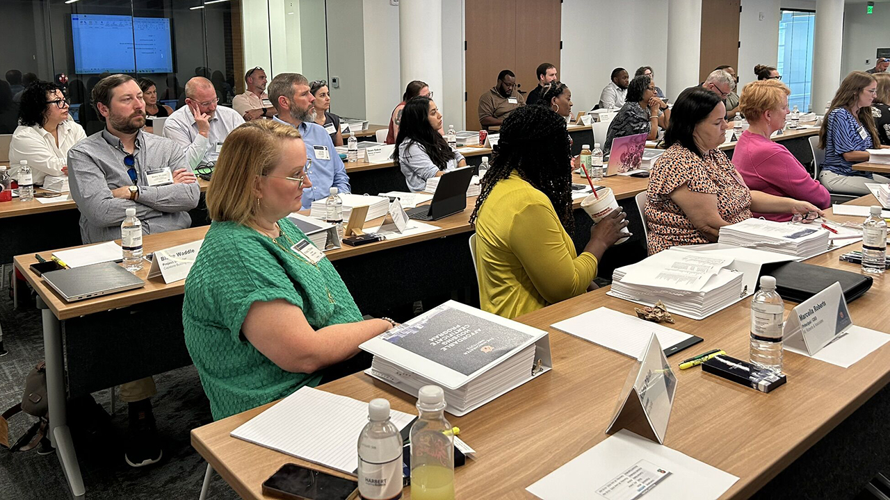 people listening to instructor in classroom