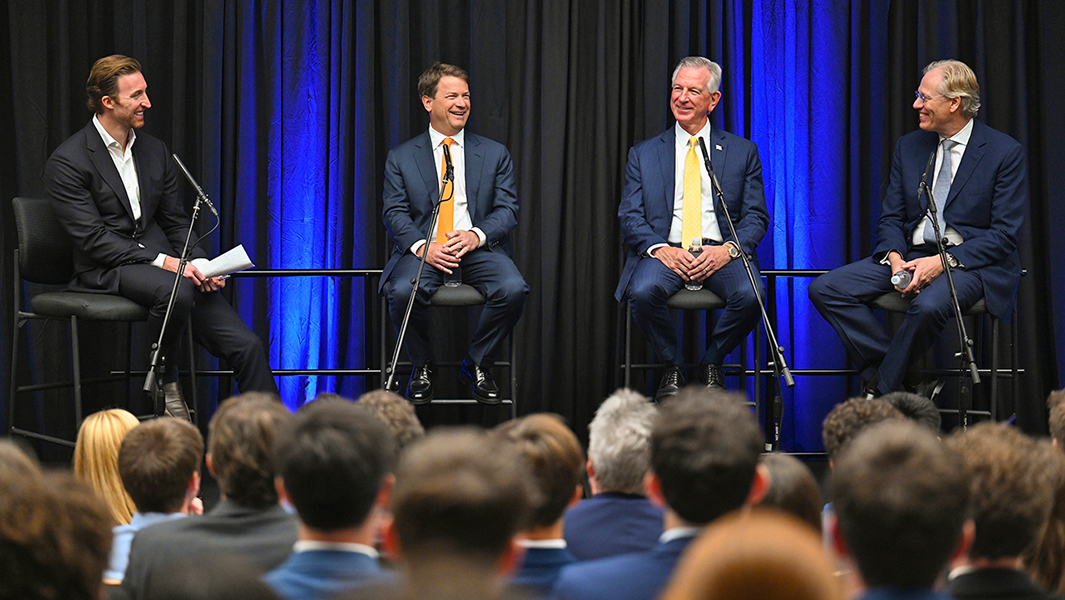 Panel of four men seated