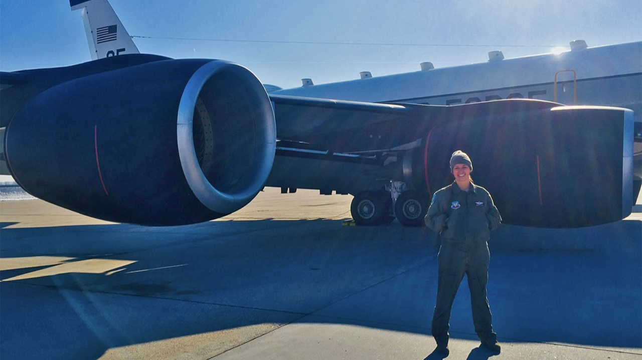 Woman AF pilot standing by plane