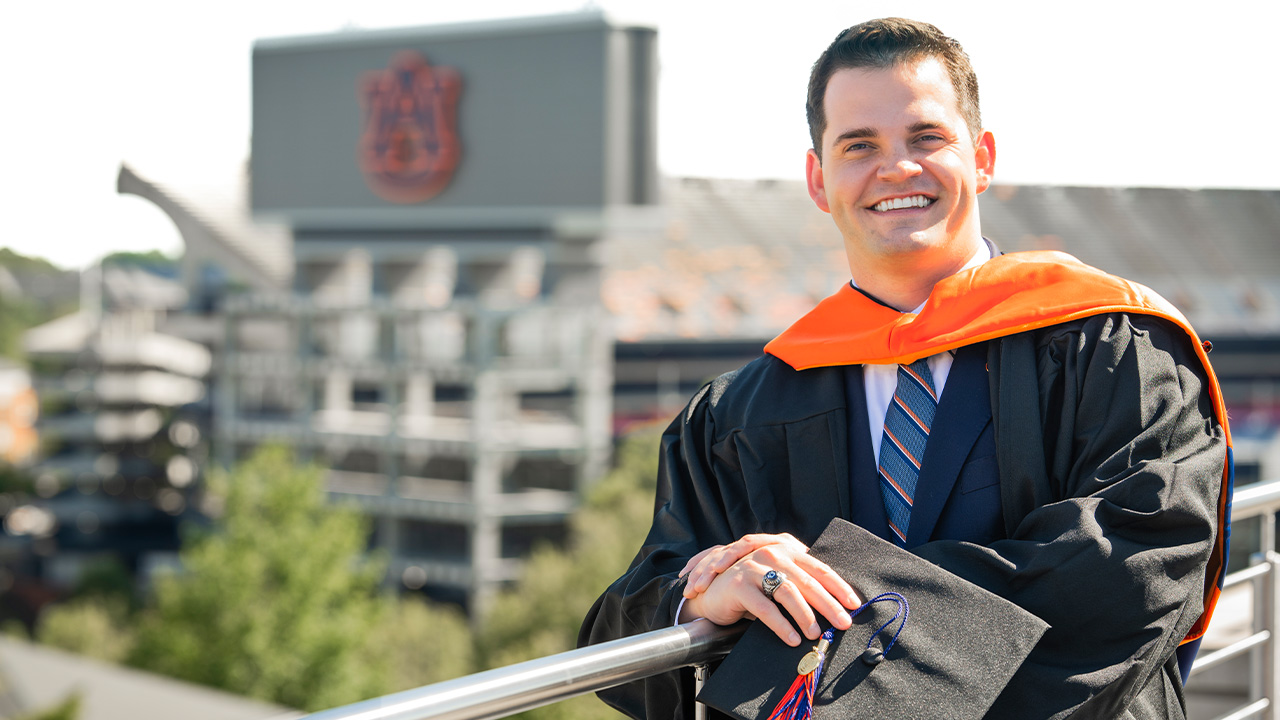 Coleman Morris MBA graduate Man standing in cap and gown