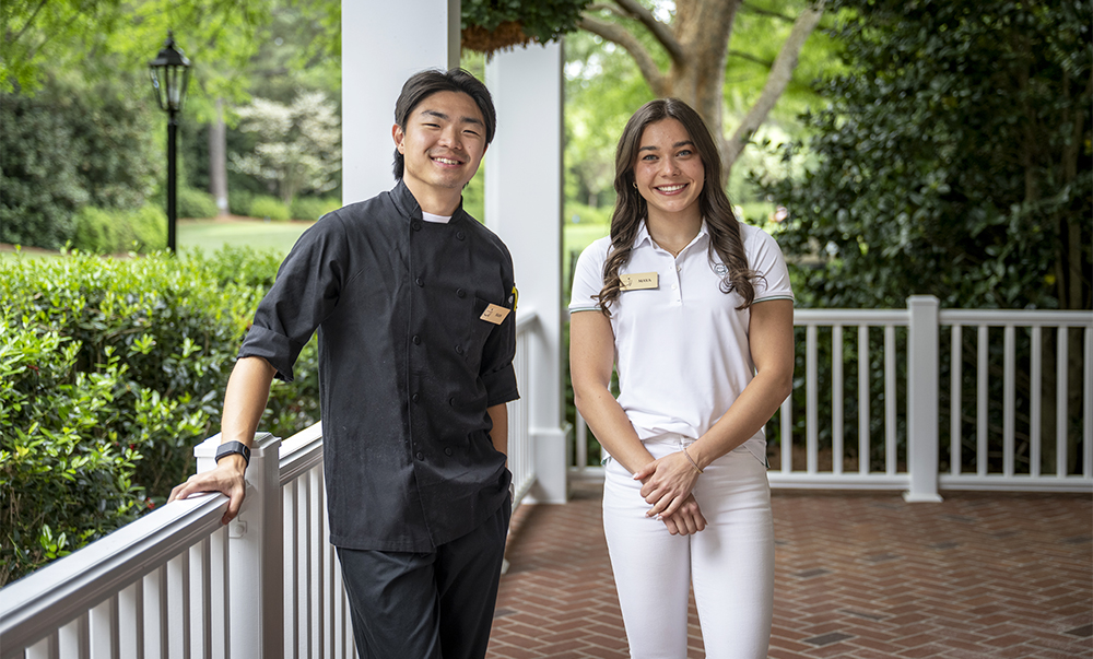 two people standing on porch