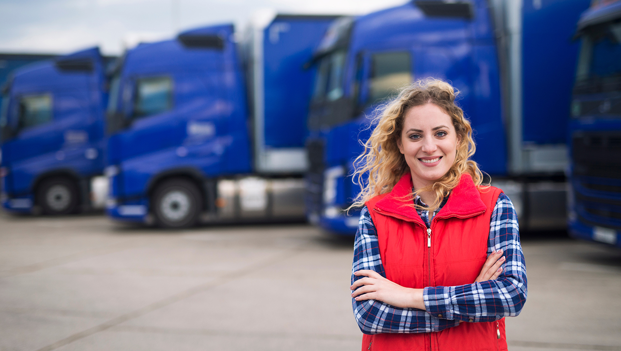 Woman standing in front of trucks