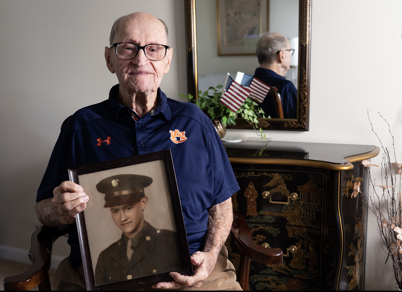 Alumnus C.a.PC Jones Alumnus C.a.PC Jones holding wwii photo of self