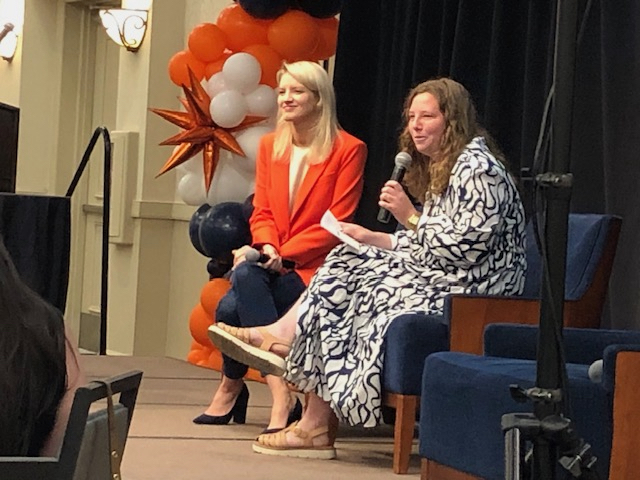 Two women speakers sitting side by side
