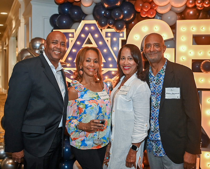 4 people standing, facing camera