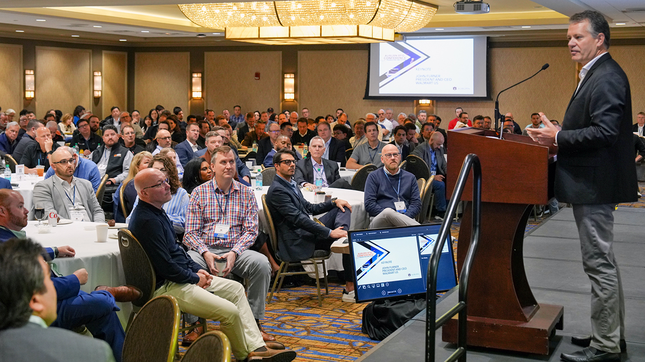 Man at podium speaking to audience