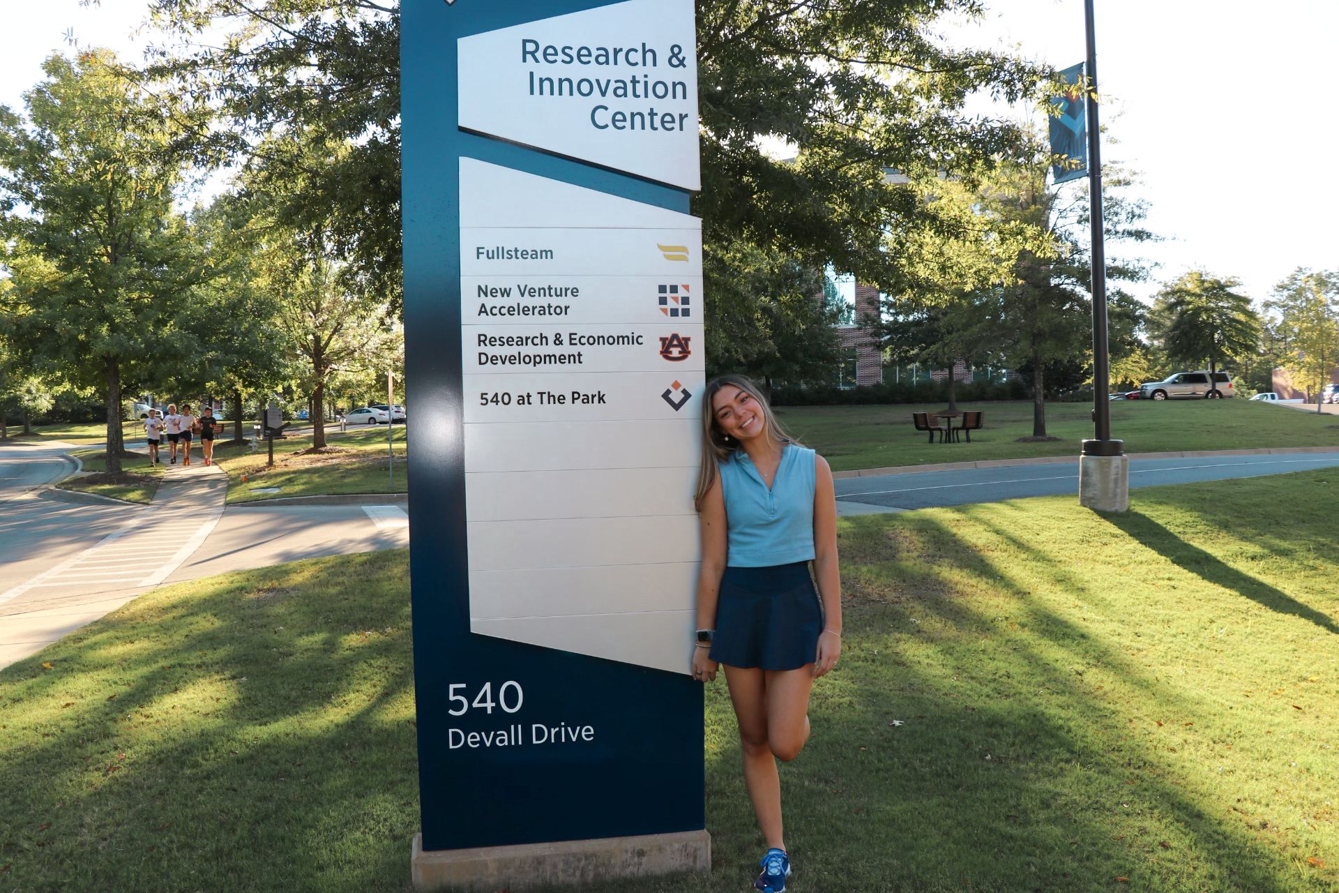 Lia Junghans in front of NVA Sign