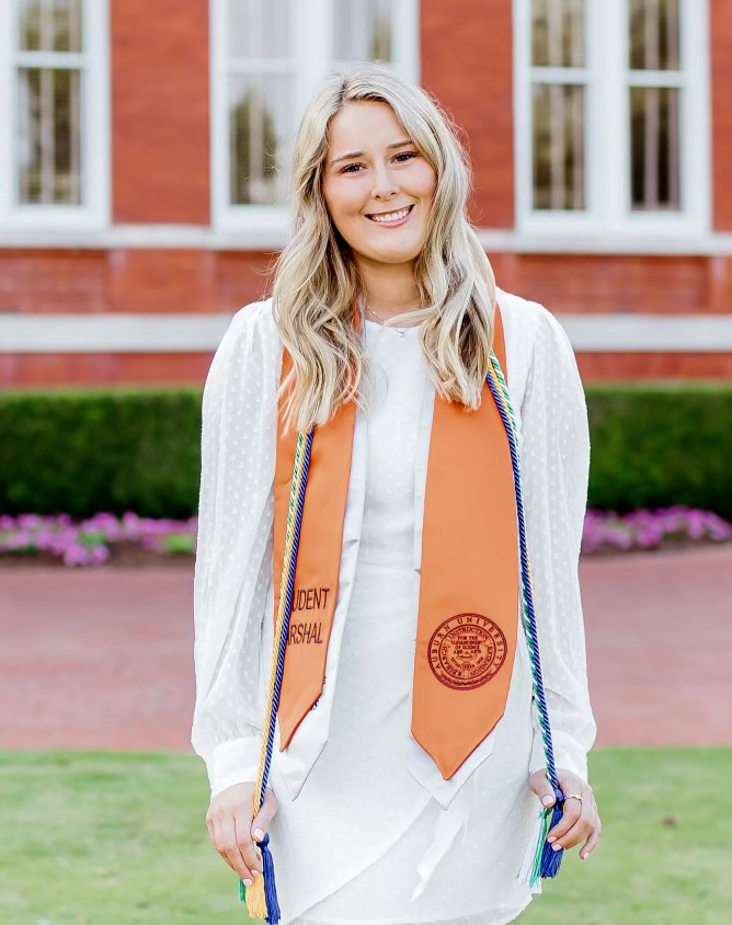 Maggie Richard wearing graduation marshal sash