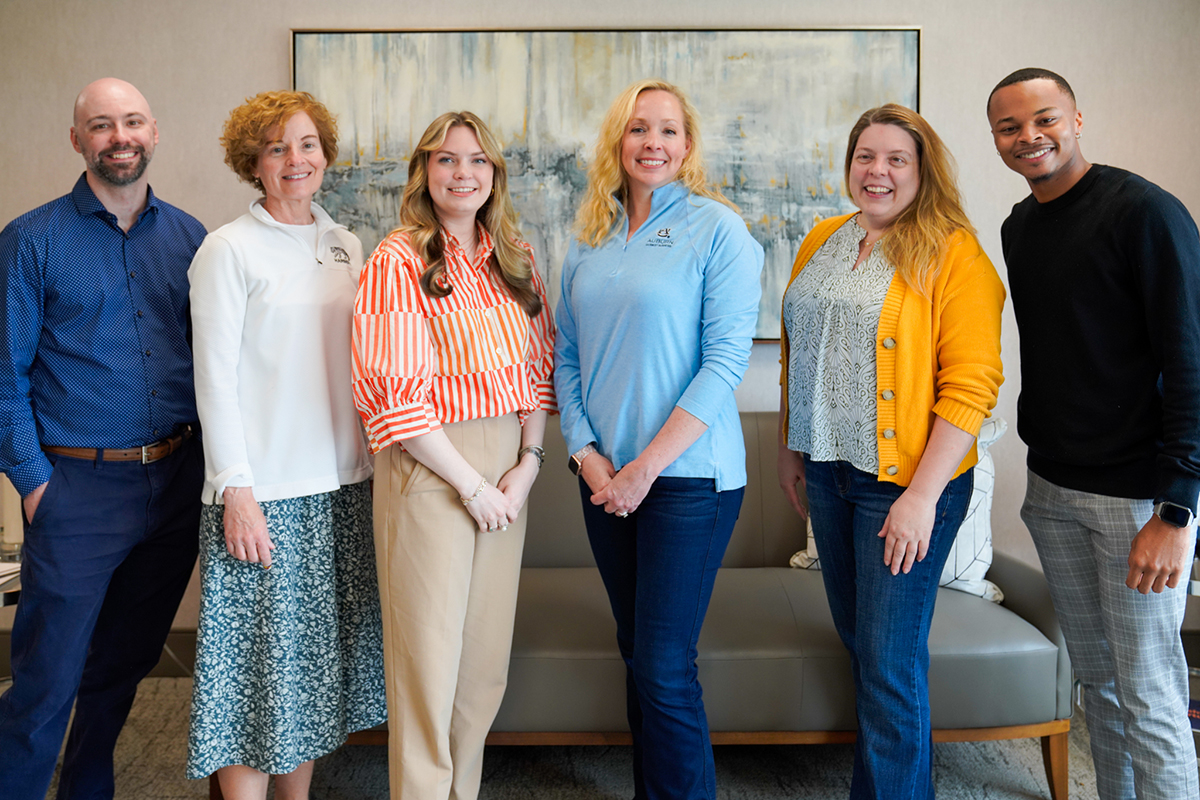 Marcom team standing in a row