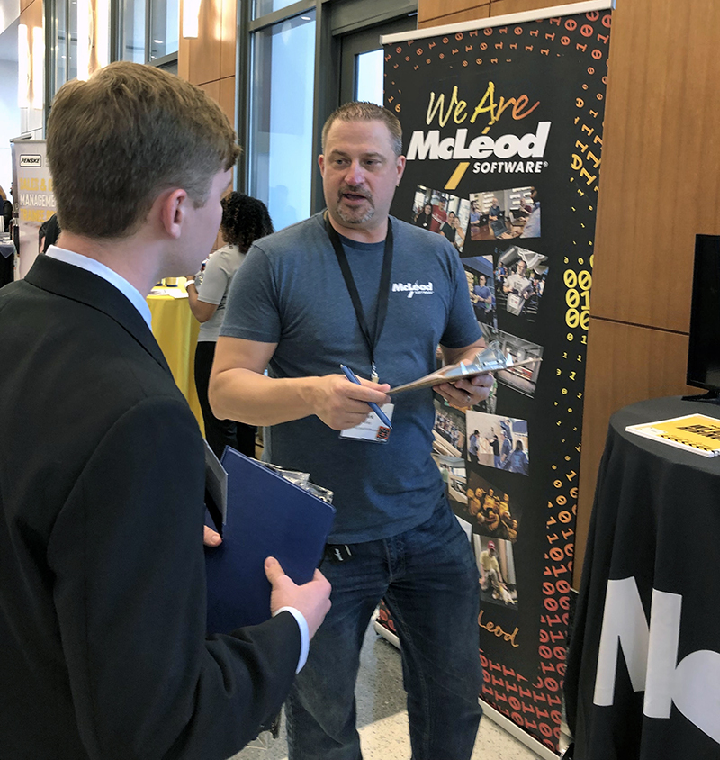 Harbert career fair McLeod rep with student