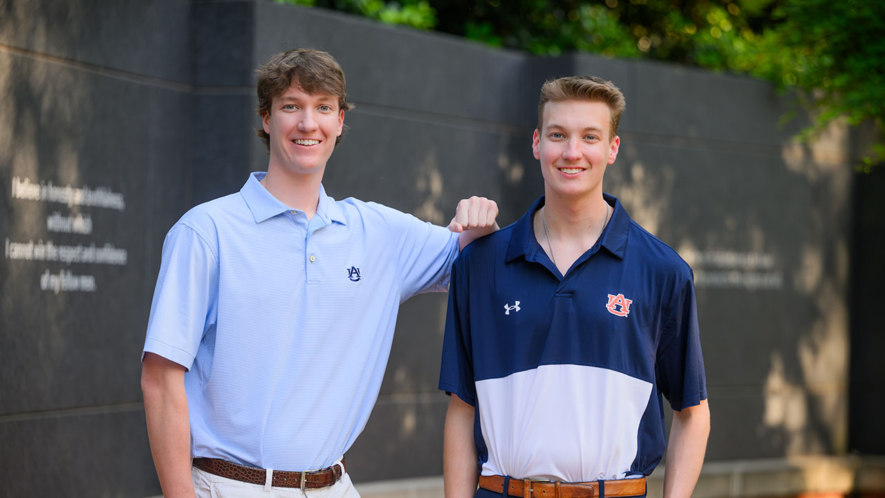 olmstead brothers standing next to each other