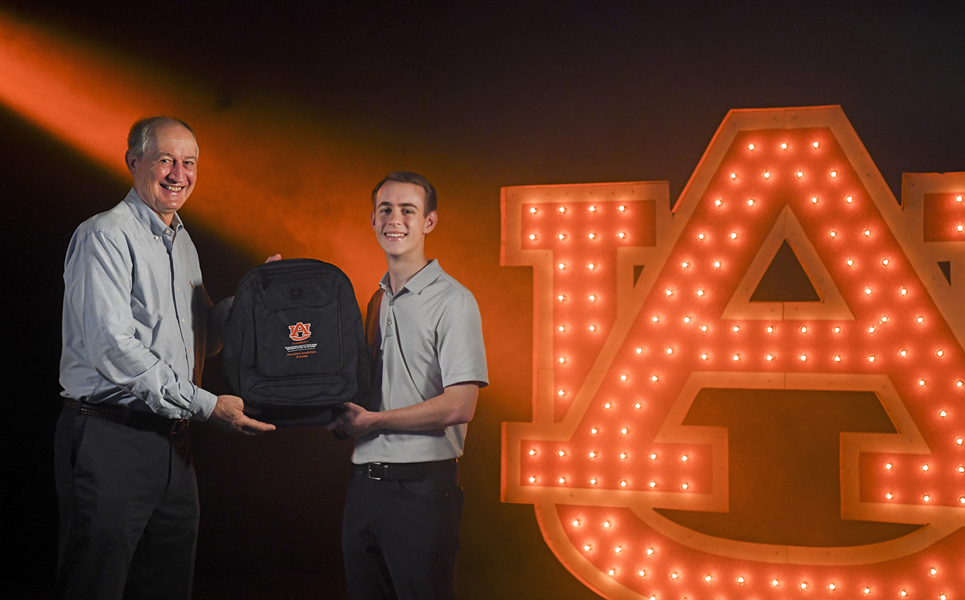 David Paradice, Kyle Davis holding Harbert backpack