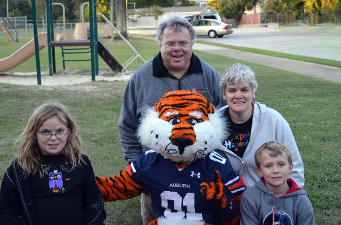 Stanwick family posing with Aubie in park