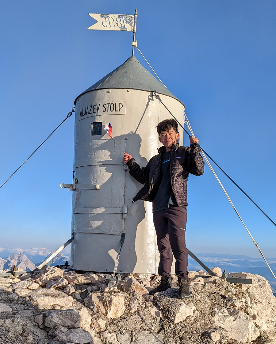 Senior Viet Nguyen standing on mountain top