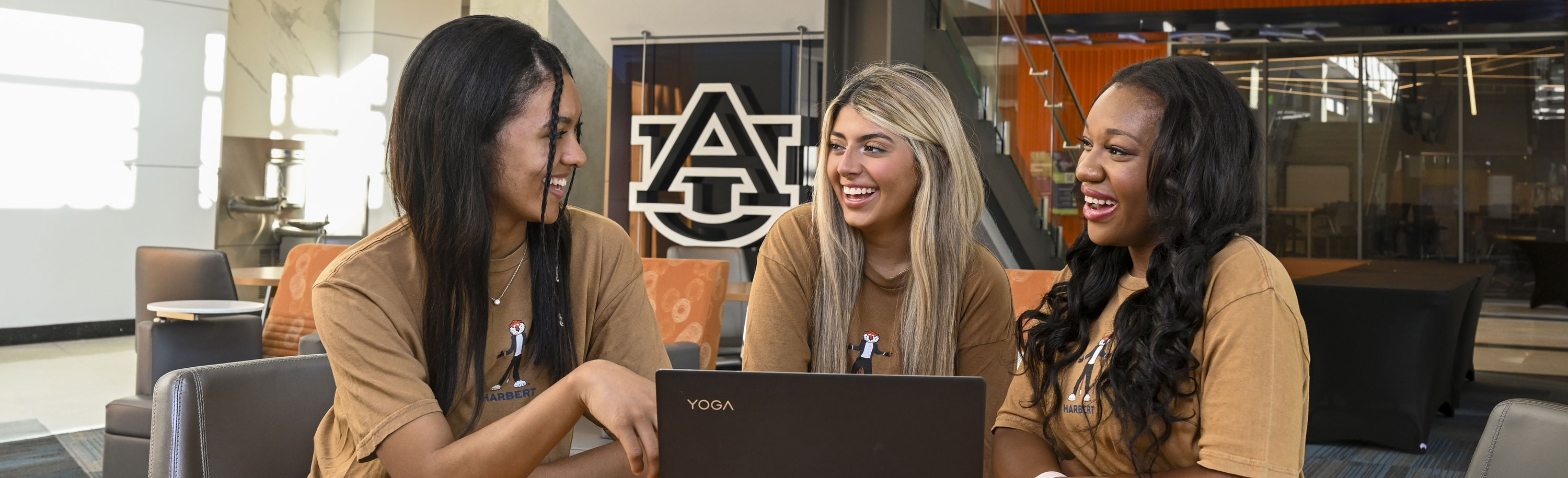 Three girls looking at laptop