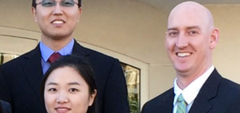 PhD in Business, Finance students smiling in front of Lowder Hall